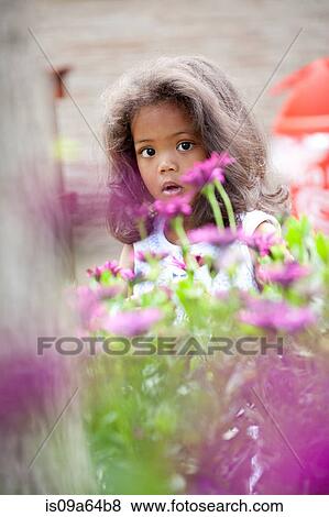 Stock Photo - Girl walking in purple flowers. Fotosearch