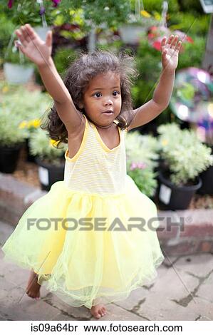 Stock Photography - Girl wearing frilly dress outdoors. Fotosearch