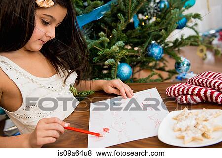 Girl writing letter to Santa at table View Large Photo Image Stock Photo - Girl writing letter to Santa at table. Fotosearch
