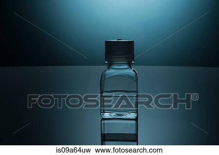 Glass bottle of clear liquid View Large Photo Image Stock Photo - Glass bottle of clear liquid. Fotosearch
