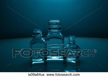 Stock Photo - Glass bottles of clear liquid. Fotosearch