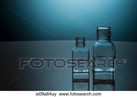 Glass bottles of clear liquid View Large Photo Image Stock Photo - Glass bottles of clear liquid. Fotosearch