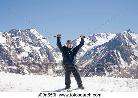 Hiker cheering on snowy mountaintop View Large Photo Image Stock Image - Hiker cheering on snowy mountaintop. Fotosearch