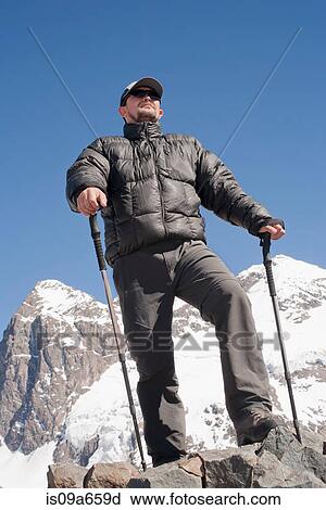 Hiker overlooking snowy mountains View Large Photo Image Stock Image - Hiker overlooking snowy mountains. Fotosearch