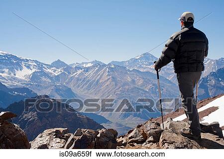 Hiker overlooking snowy mountains View Large Photo Image Stock Image - Hiker overlooking snowy mountains. Fotosearch