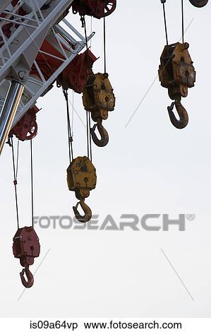 Hooks hanging from crane View Large Photo Image Stock Photography - Hooks hanging from crane. Fotosearch