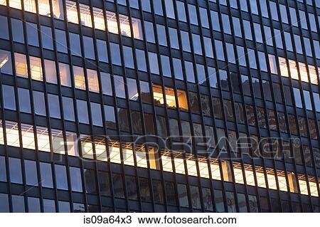 Stock Image - Illuminated windows of skyscraper. Fotosearch