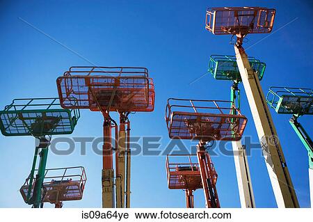 Stock Image - Low angle view of cherry pickers. Fotosearch