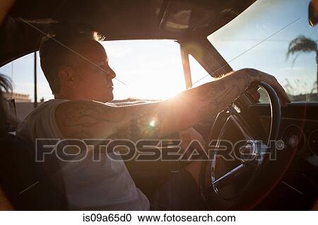 Man driving vintage car at sunset View Large Photo Image Stock Image - Man driving vintage car at sunset. Fotosearch