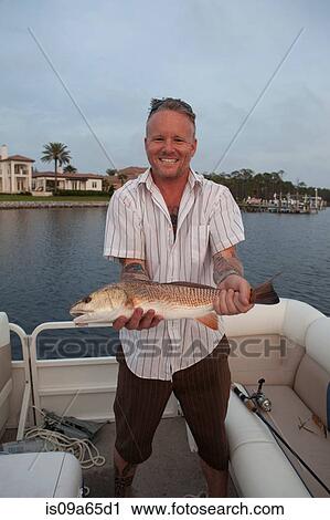 Man holding catch of fish in boat View Large Photo Image Stock Image - Man holding catch of fish in boat. Fotosearch