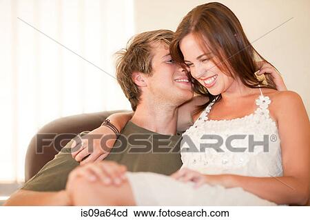 Man holding girlfriend on his lap View Large Photo Image Stock Image - Man holding girlfriend on his lap. Fotosearch