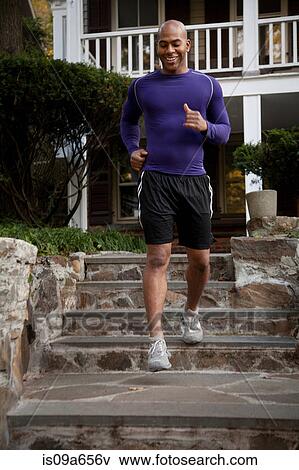 Stock Photo - Man jogging on steps outdoors. Fotosearch