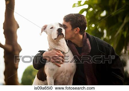 Man kissing dog outdoors View Large Photo Image Stock Image - Man kissing dog outdoors. Fotosearch