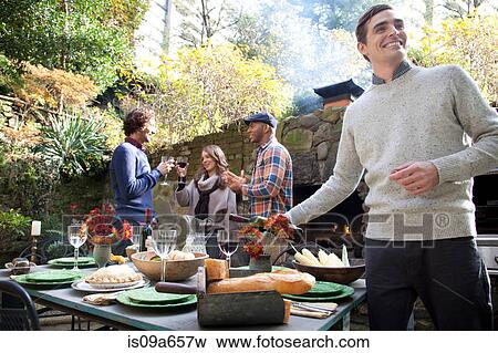 Stock Photo - Man pouring glass of wine at table. Fotosearch