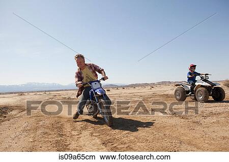 Man riding dirt bike in desert View Large Photo Image Picture - Man riding dirt bike in desert. Fotosearch