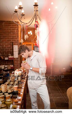 Man smelling preserves in grocery View Large Photo Image Stock Image - Man smelling preserves in grocery. Fotosearch