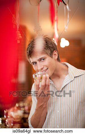 Man smelling preserves in grocery View Large Photo Image Stock Image - Man smelling preserves in grocery. Fotosearch