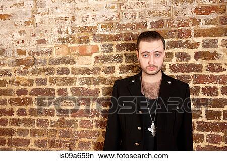 Man standing by brick wall View Large Photo Image Picture - Man standing by brick wall. Fotosearch
