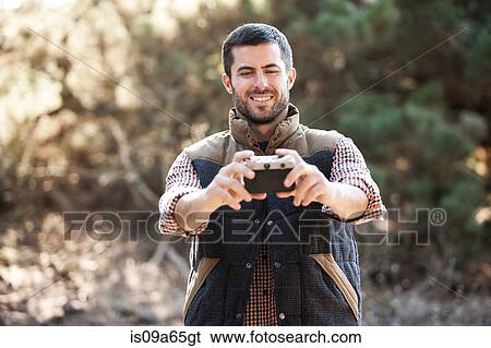 Man taking picture of himself outdoors View Large Photo Image Stock Photograph - Man taking picture of himself outdoors. Fotosearch