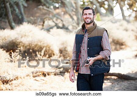 Stock Photograph - Man taking pictures outdoors. Fotosearch
