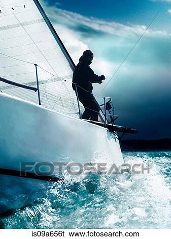 Man trimming sails on yacht in race View Large Photo Image Stock Photograph - Man trimming sails on yacht in race. Fotosearch