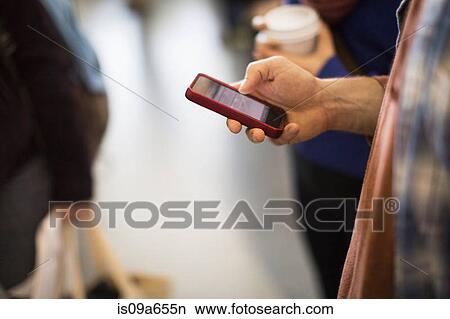 Man using cell phone indoors View Large Photo Image Picture - Man using cell phone indoors. Fotosearch