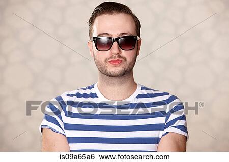 Stock Photograph - Man wearing sunglasses indoors. Fotosearch