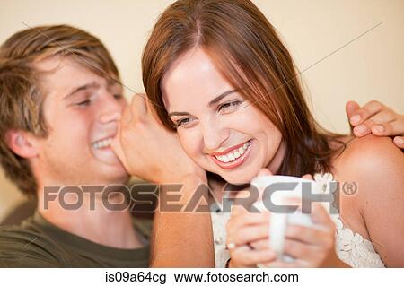 Man whispering in girlfriend's ear View Large Photo Image Stock Image - Man whispering in girlfriend's ear. Fotosearch