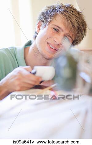 Stock Photo - Man working on model airplane. Fotosearch