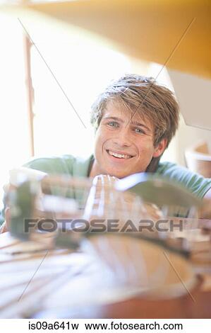 Stock Photo - Man working on model airplane. Fotosearch