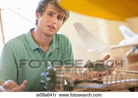 Man working on model airplane View Large Photo Image Stock Photography - Man working on model airplane. Fotosearch