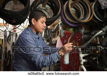 Mechanic working in bicycle shop View Large Photo Image Stock Image - Mechanic working in bicycle shop. Fotosearch