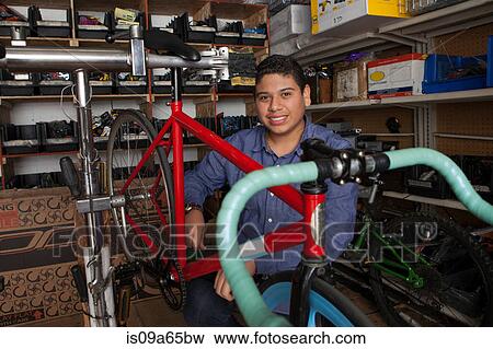 Mechanic working in bicycle shop View Large Photo Image Stock Photo - Mechanic working in bicycle shop. Fotosearch