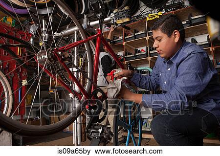 Mechanic working in bicycle shop View Large Photo Image Stock Photo - Mechanic working in bicycle shop. Fotosearch