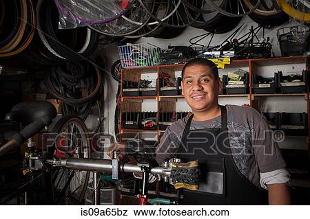 Stock Photo - Mechanic working in bicycle shop. Fotosearch