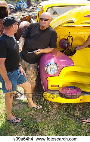 Picture - Mechanics working on colorful car. Fotosearch