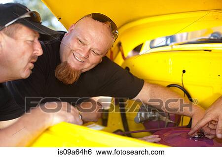 Mechanics working on colorful car View Large Photo Image Stock Photograph - Mechanics working on colorful car. Fotosearch