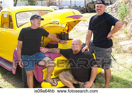Men smiling with colorful car View Large Photo Image Stock Image - Men smiling with colorful car. Fotosearch