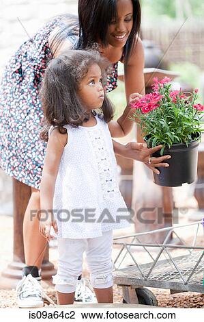 Mother and daughter at plant nursery View Large Photo Image Stock Image - Mother and daughter at plant nursery. Fotosearch