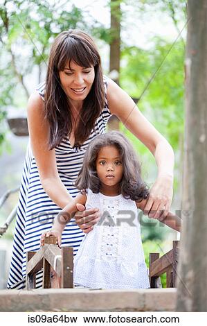 Stock Photo - Mother and daughter playing outdoors. Fotosearch