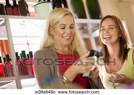Mother and daughter shopping for vinegar View Large Photo Image Picture - Mother and daughter shopping for vinegar. Fotosearch