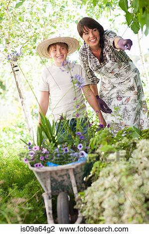 Stock Image - Mother and son gardening outdoors. Fotosearch
