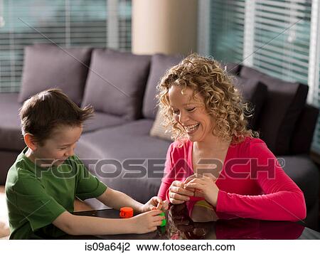 Stock Image - Mother and son playing together. Fotosearch