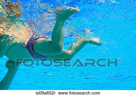 Stock Photography - Mother helping toddler swim in pool. Fotosearch