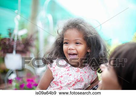 Stock Photo - Mother holding laughing daughter. Fotosearch