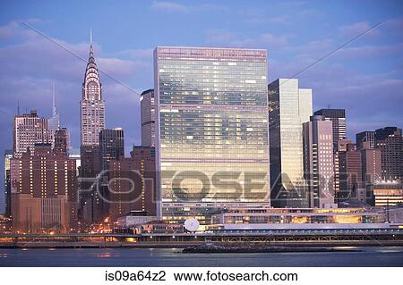 Stock Image - New York City skyline lit up at dusk. Fotosearch