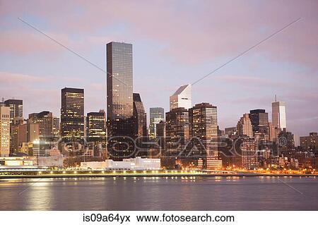 New York City skyline lit up at dusk View Large Photo Image Stock Photo - New York City skyline lit up at dusk. Fotosearch