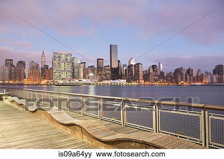Stock Photo - New York City skyline lit up at dusk. Fotosearch