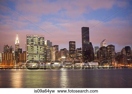 New York City skyline lit up at night View Large Photo Image Stock Photo - New York City skyline lit up at night. Fotosearch