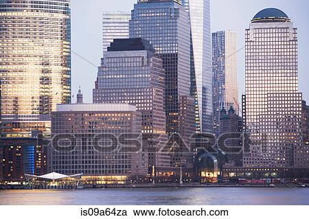 Stock Image - New York City skyscrapers lit up at dusk. Fotosearch